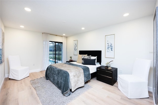 bedroom with access to exterior and light wood-type flooring