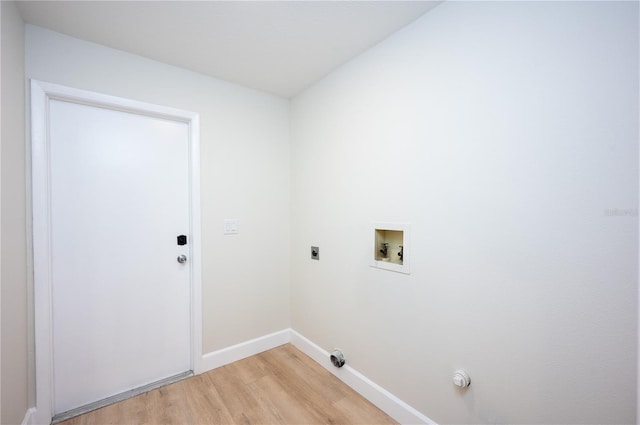 washroom with hookup for an electric dryer, washer hookup, and light hardwood / wood-style flooring