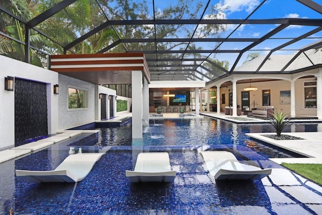 view of swimming pool with pool water feature, glass enclosure, ceiling fan, an outdoor living space, and a patio