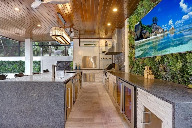 view of patio with sink, wine cooler, exterior kitchen, grilling area, and ceiling fan