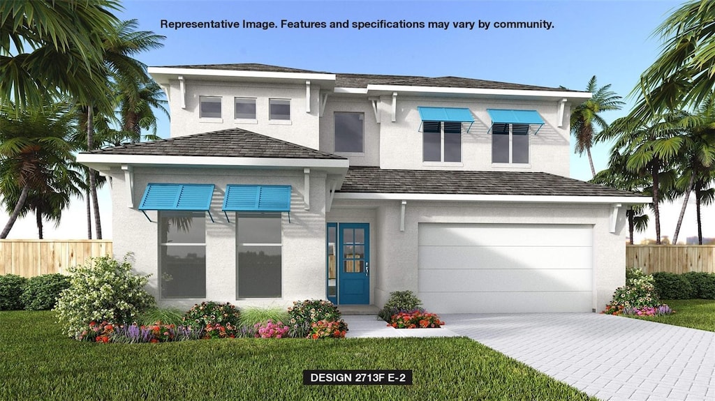 view of front of property featuring a garage and a front lawn