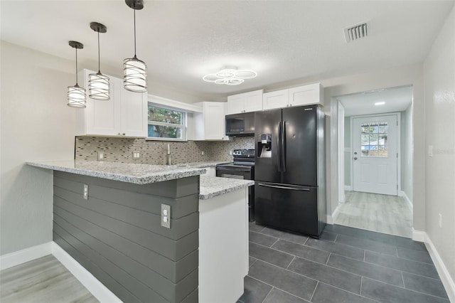 kitchen with hanging light fixtures, tasteful backsplash, black appliances, white cabinets, and kitchen peninsula