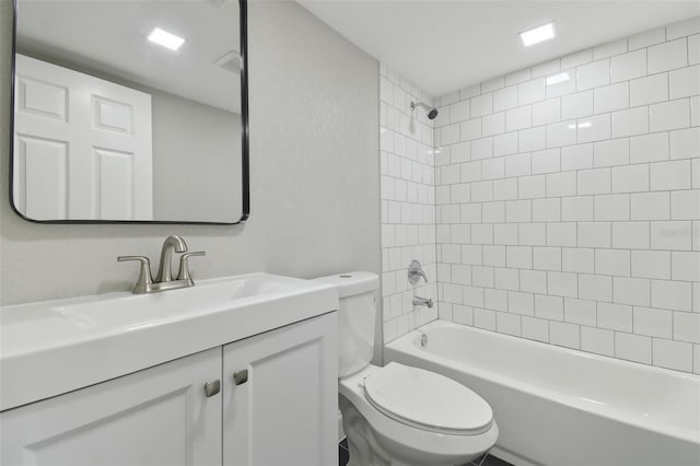 full bathroom with vanity, toilet, and tiled shower / bath