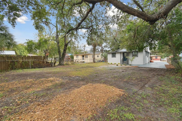 view of yard with entry steps and fence