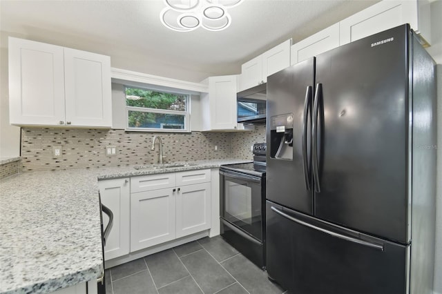 kitchen featuring tasteful backsplash, black range with electric cooktop, refrigerator with ice dispenser, light stone countertops, and white cabinets