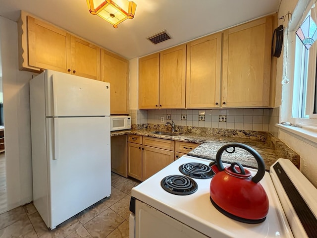 kitchen featuring sink, white appliances, light tile patterned floors, backsplash, and light brown cabinetry