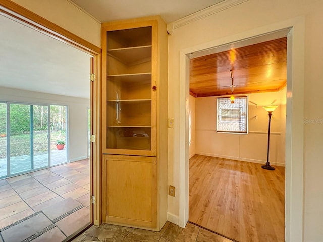 corridor featuring wood ceiling and ornamental molding