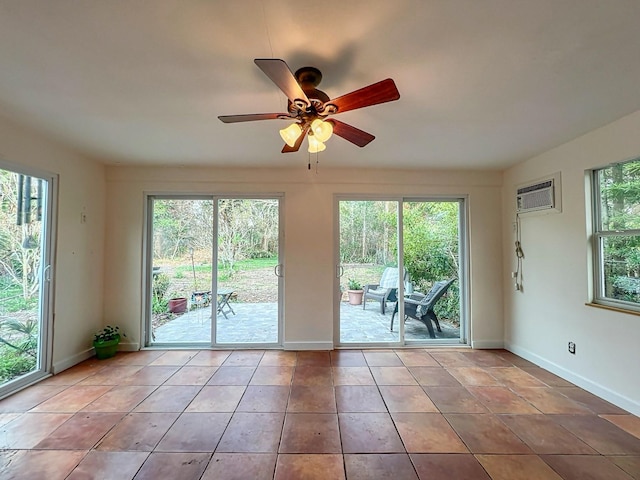 entryway with ceiling fan, a wall unit AC, and light tile patterned floors