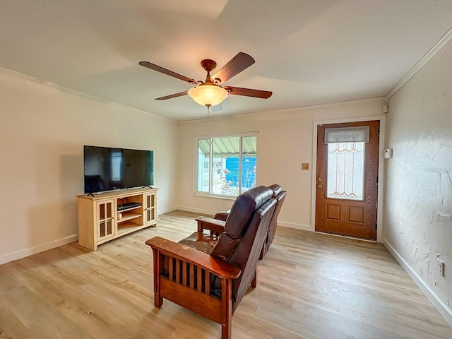 living room featuring crown molding, ceiling fan, and light wood-type flooring