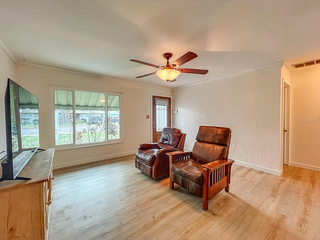 sitting room with ornamental molding, ceiling fan, and light hardwood / wood-style flooring