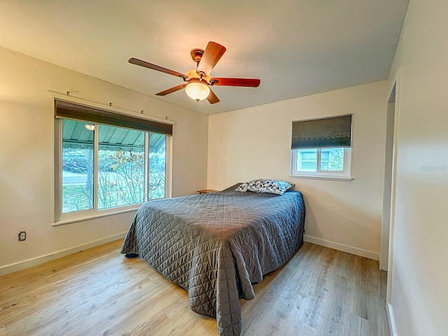 bedroom with ceiling fan and light hardwood / wood-style floors