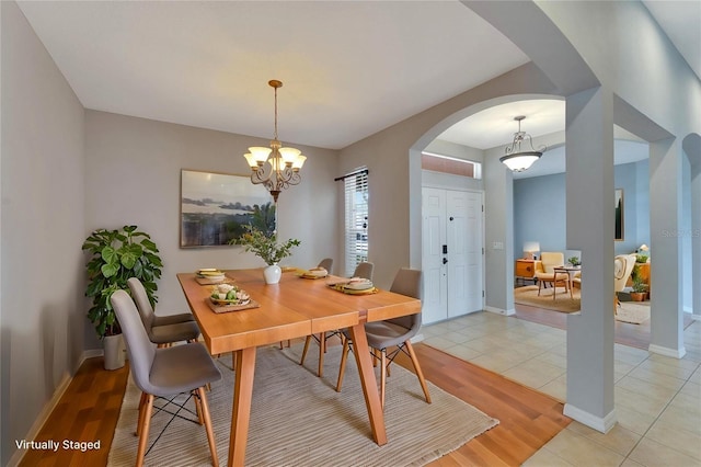 tiled dining space featuring a chandelier