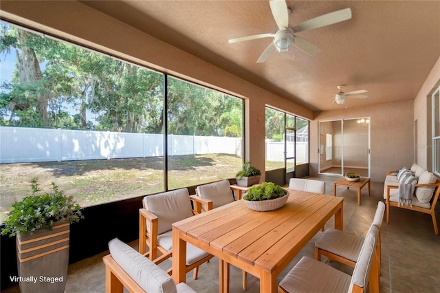 sunroom / solarium featuring ceiling fan