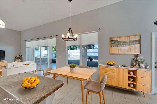 tiled dining area featuring an inviting chandelier