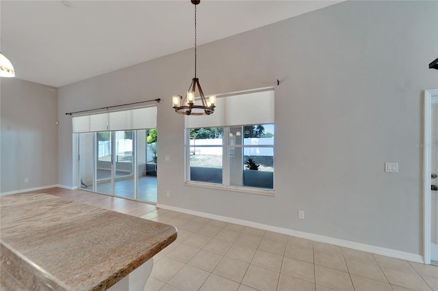 tiled dining space with a chandelier