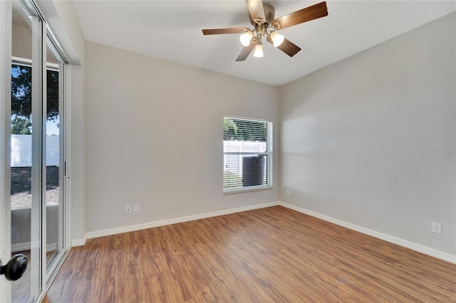 spare room with hardwood / wood-style floors and ceiling fan