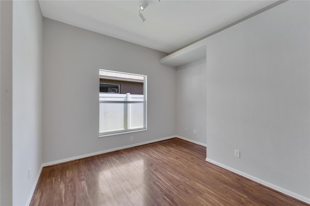 spare room featuring wood-type flooring