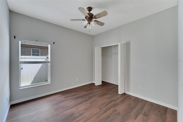 unfurnished bedroom featuring dark hardwood / wood-style floors, ceiling fan, and a closet