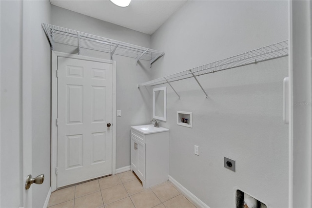 laundry area featuring washer hookup, sink, hookup for an electric dryer, and light tile patterned floors