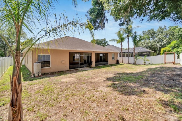 rear view of property featuring a yard