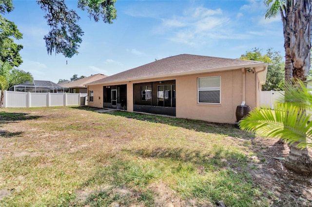 rear view of property with a lawn