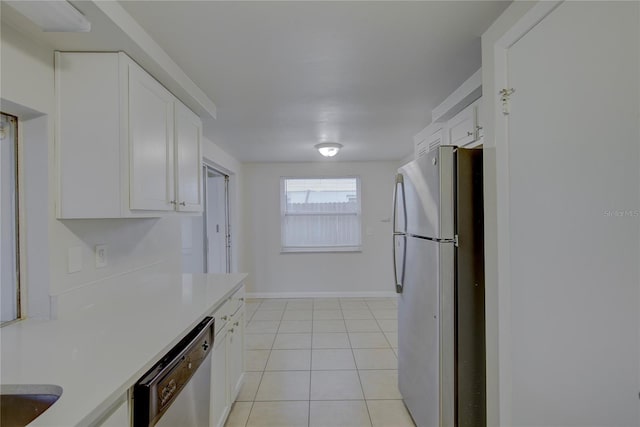 kitchen featuring light tile patterned flooring, appliances with stainless steel finishes, and white cabinets