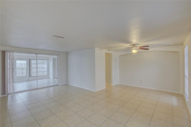 tiled spare room with ceiling fan