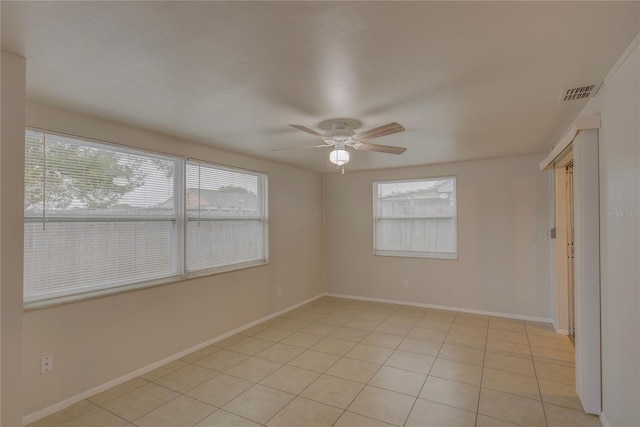 unfurnished room featuring light tile patterned floors and ceiling fan