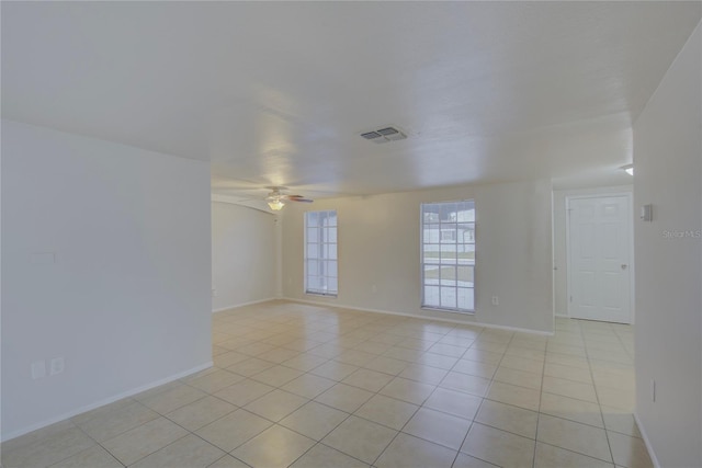 unfurnished room featuring light tile patterned floors and ceiling fan