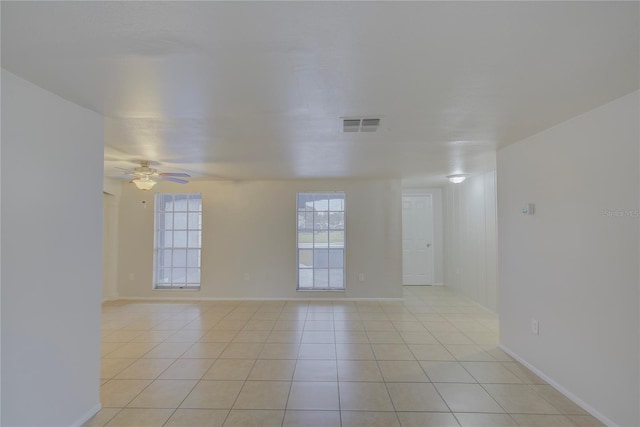 empty room featuring light tile patterned floors and ceiling fan