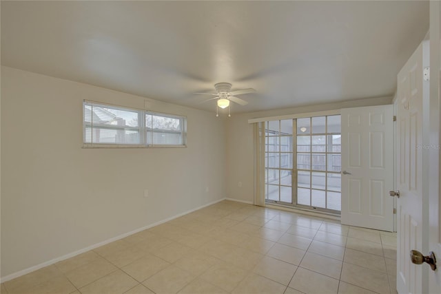 unfurnished room with ceiling fan and light tile patterned floors