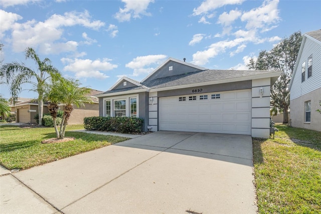 single story home featuring a garage and a front lawn