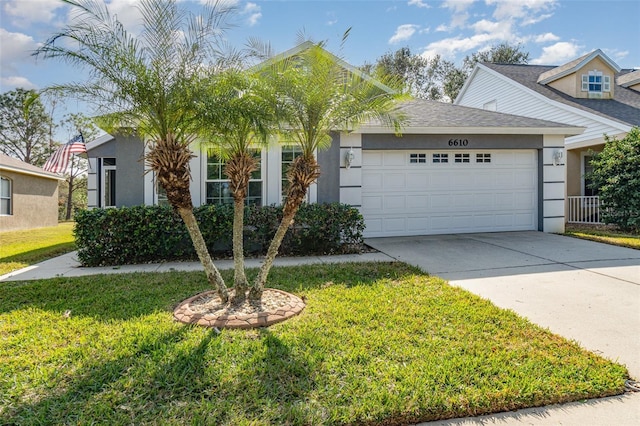 view of front of home with a garage and a front yard