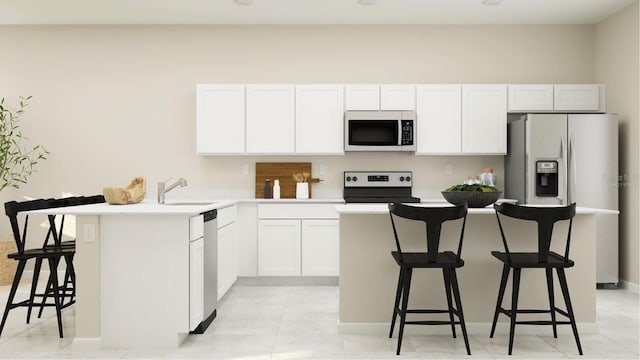 kitchen with sink, a breakfast bar area, white cabinetry, a kitchen island, and stainless steel appliances