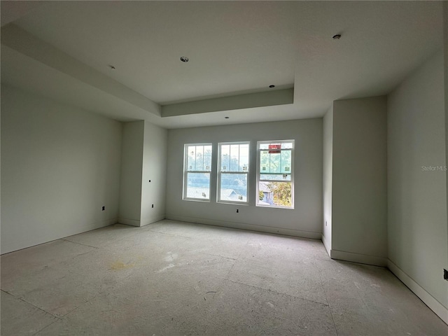 unfurnished room with a tray ceiling