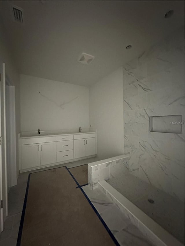 bathroom with vanity and a shower