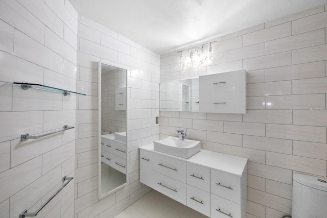 bathroom with tile walls and vanity