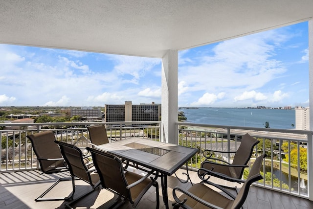 wooden deck featuring a water view and a city view