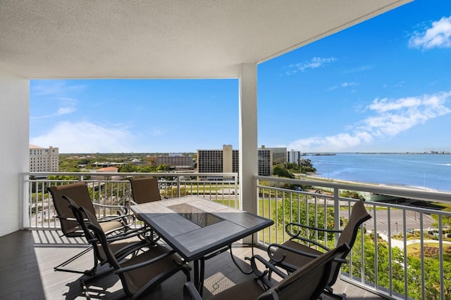 balcony with a water view and a city view