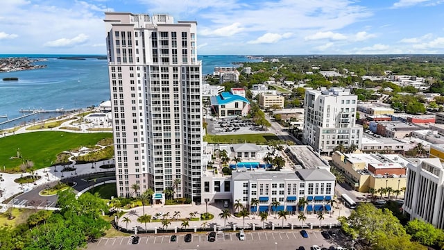 drone / aerial view featuring a view of city and a water view