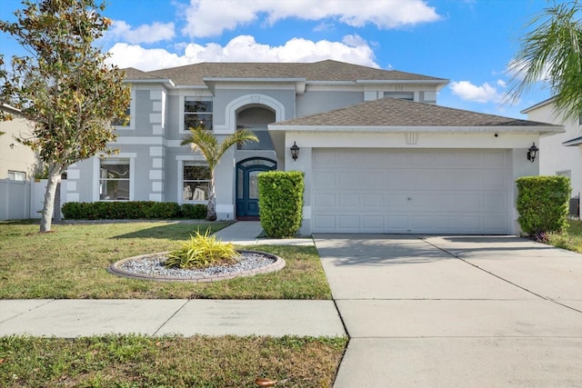 view of front of house featuring a garage and a front yard