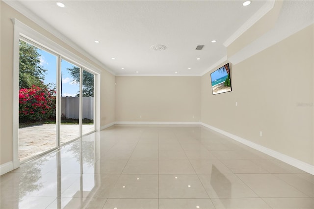 empty room with crown molding and light tile patterned flooring