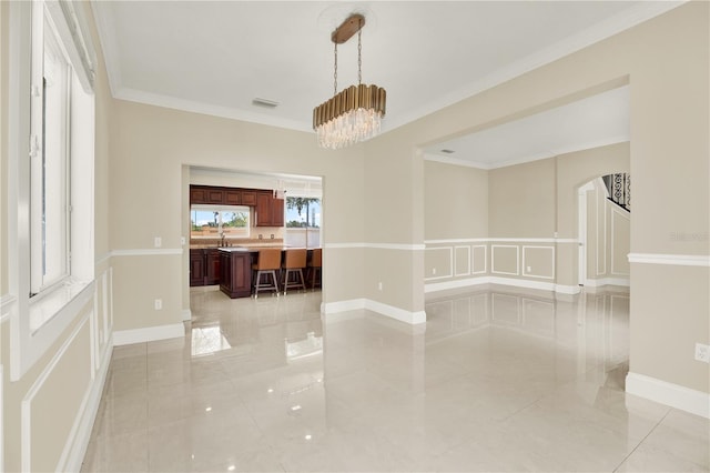 interior space featuring an inviting chandelier and ornamental molding