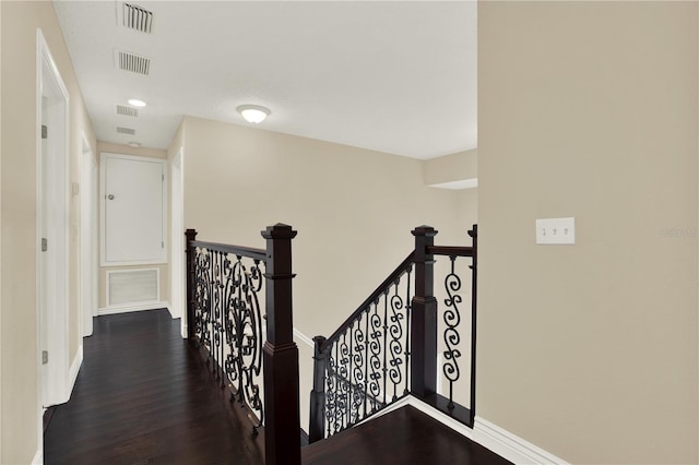 corridor featuring dark wood-type flooring