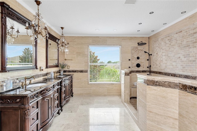 bathroom with tiled shower, a healthy amount of sunlight, tile walls, and vanity