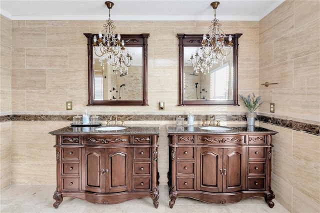 bathroom featuring tile walls, vanity, crown molding, and a chandelier