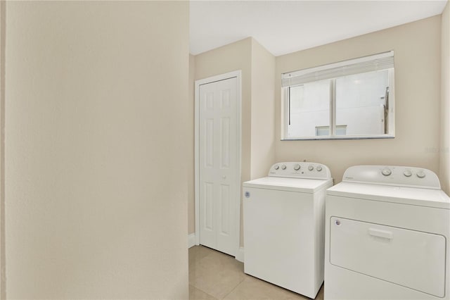 washroom featuring separate washer and dryer and light tile patterned flooring