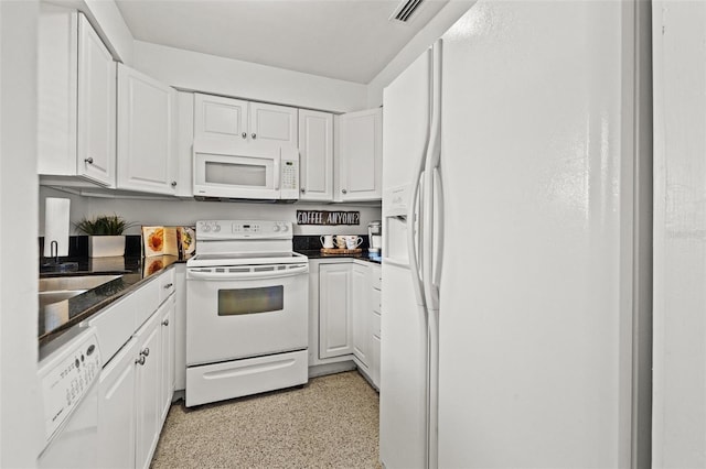 kitchen with white cabinetry and white appliances