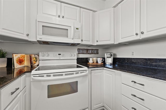 kitchen featuring white cabinetry, white appliances, and dark stone countertops