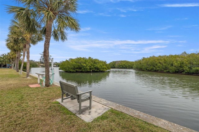 dock area with a lawn and a water view